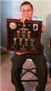 Tony Becerra Holding War Badges of Honor