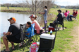 Family Sitting Beside Lake