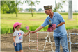 Veteran Handing a Flag to a Girl