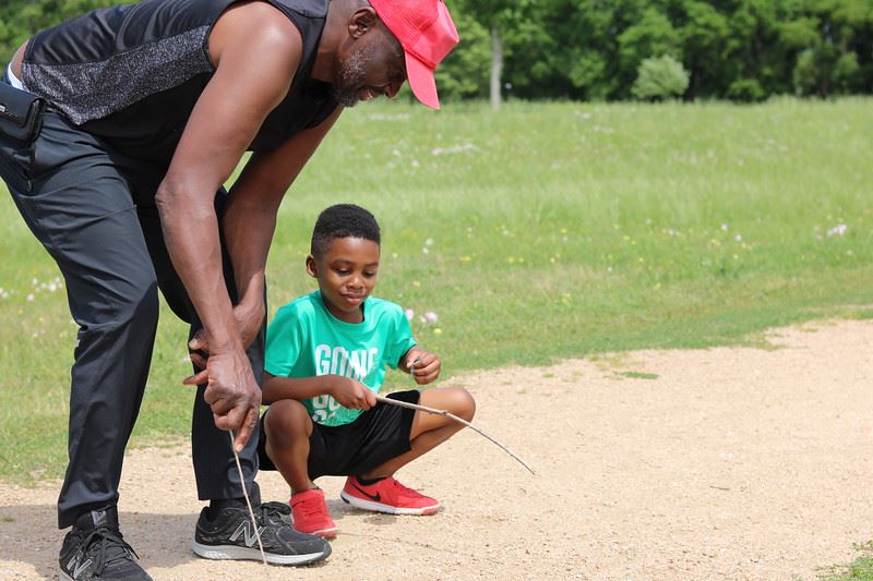 Man and Boy Playing with Sticks