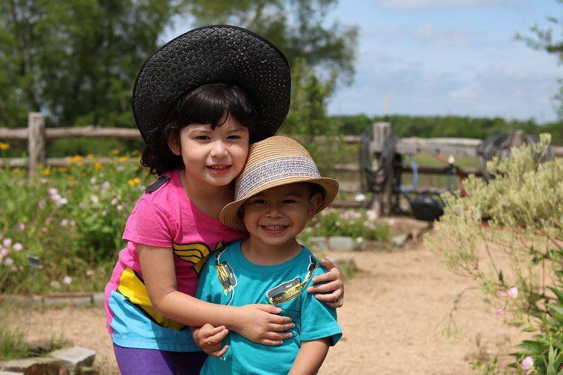 Siblings Posing with Hats
