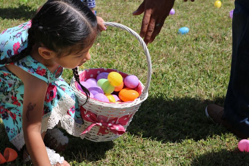Girl Picking up an Easter Egg
