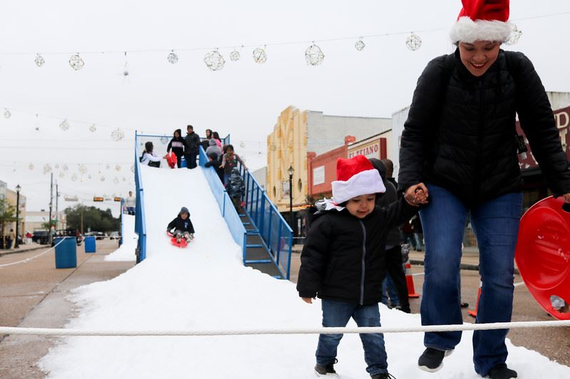 People Sliding down a Snow Slide